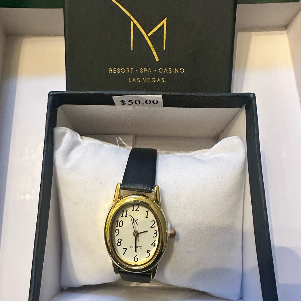 Women’s gold toned watch with black strap. NIB from M hotel in Las Vegas.